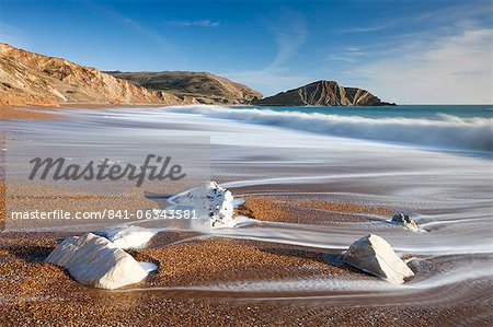 Waves wash clean the beautiful beach at Worbarrow Bay on the Jurassic Coast, UNESCO World Heritage Site, Dorset, England, United Kingdom, Europe