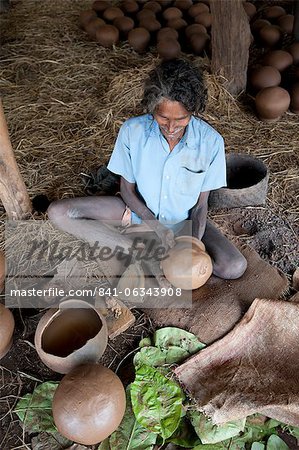 Potter making clay water pots in a thatched shelter in a rural village, near Rayagada, Orissa, India, Asia