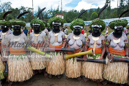 Colourfully dressed and face painted local ladies celebrating the traditional Sing Sing in the Highlands of Papua New Guinea, Pacific