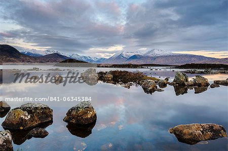 Snow covered mountains at dawn, Lochan na h Achlaise, Rannoch Moor, Argyll and Bute, Scottish Highlands, Scotland