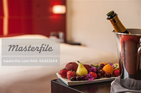 Fruit plate and champagne in hotel room