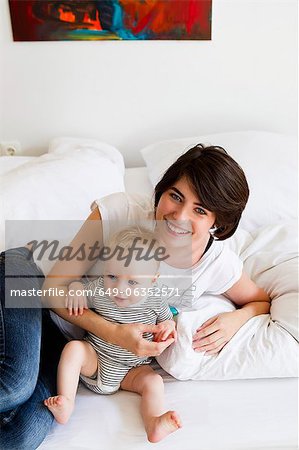 Mother and baby relaxing on couch