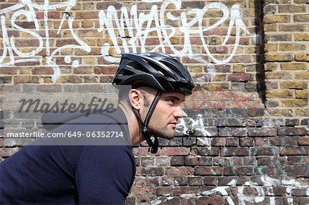Man riding bicycle on city street Man riding bicycle on city street