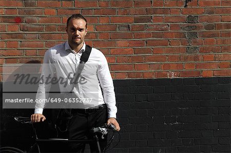 Homme d'affaires à bicyclette sur la rue de ville