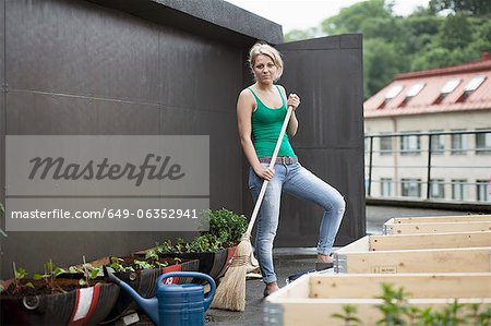 Teenage girl working in modern garden