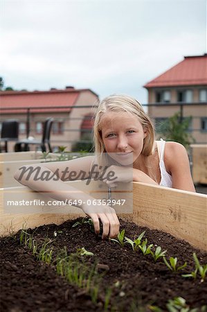 Teenage girl planting seedlings