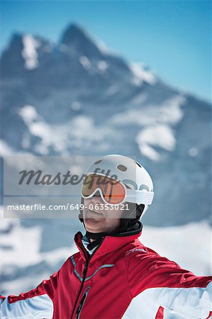 Skier standing on snowy mountain