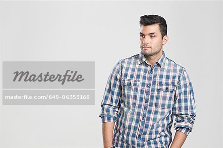 Man standing with hands in pockets Man standing with hands in pockets