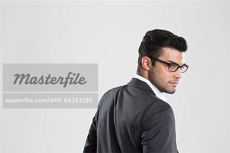 Businessman looking over his shoulder