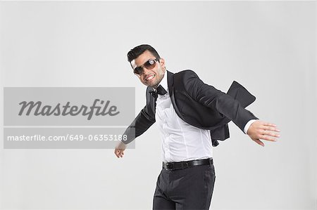 Smiling man in tuxedo dancing