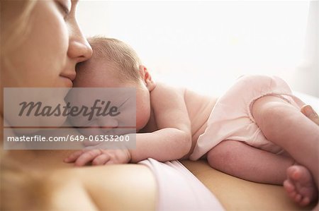 Mother cradling newborn infant