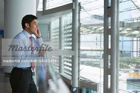 Businessman on cell phone in office