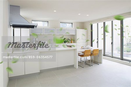 Modern Kitchen Interior And Floating Green Leaves