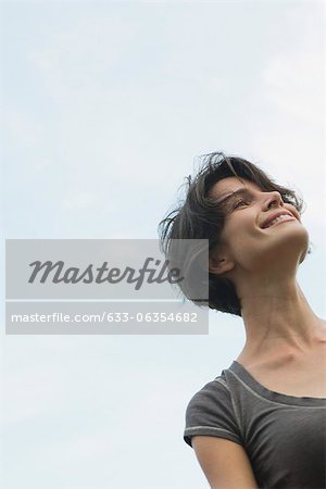 Woman smiling outdoors, low angle view