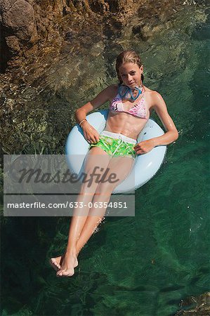 Preteen girl floating on water