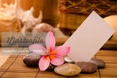 tropical spa with frangipani flowers arrangement and blank card for ads purpose