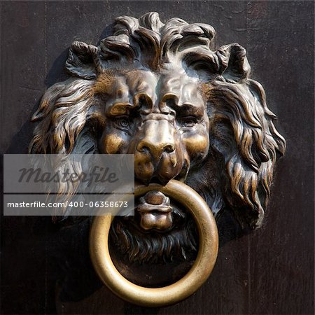 Antique lion's head doorknocker in Aachen, Germany