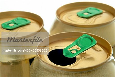 three cans of gold paint on a white background