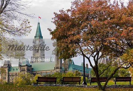 The canadian Parliament seen from park benches in Major's Hill park in Ottawa, Canada.
