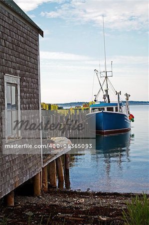 A lobster boat at dock with traps ready for the next sason