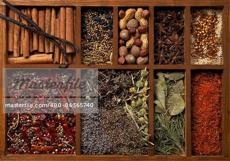 Nine Sections in Wooden Box with Mixed Spices, Herbs and Dried Leafs close up