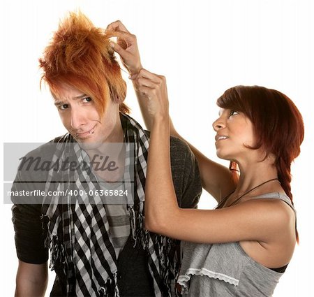 Cute young woman picking at her friends hair