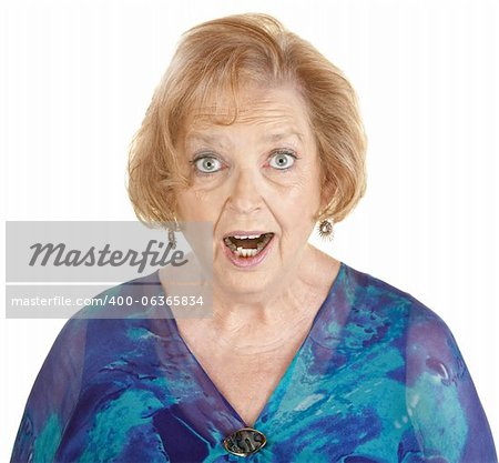 Awestruck elderly woman in blue on isolated background