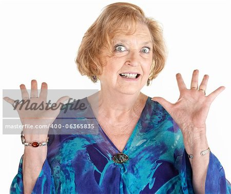 Frightened European senior female with hands up