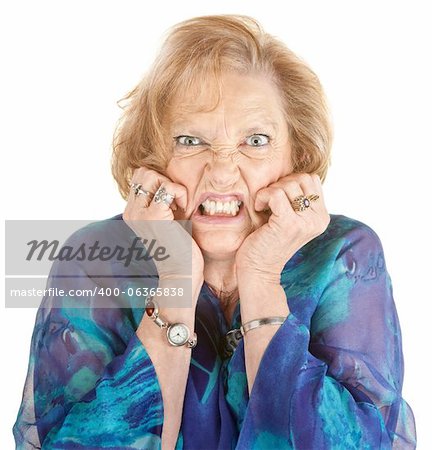 Furious elderly woman with hands on face