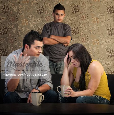 Worried Native American couple with upset son indoors