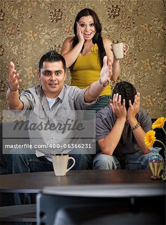 Excited man and woman with distraught son watching television