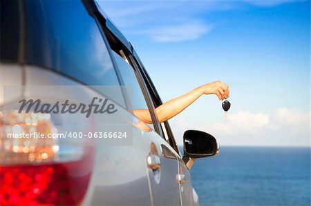 hand of woman holding car key