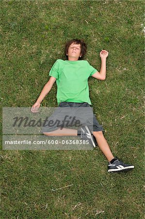 Boy Lying on Grass, Ile de Re, Poitou-Charentes, France