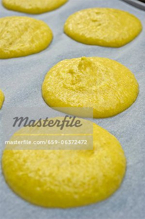 Piles of macaroon dough on baking paper