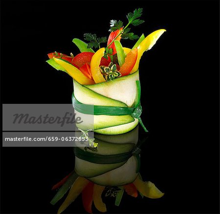 Colourful pepper sticks and parsley wrapped in a courgette slice