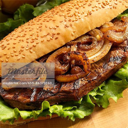 Grilled Steak and Onion Sandwich with Lettuce on a Roll