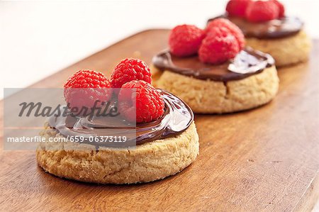 Shortbread Cookies with Chocolate Hazelnut Spread and Raspberries; On Cutting Board