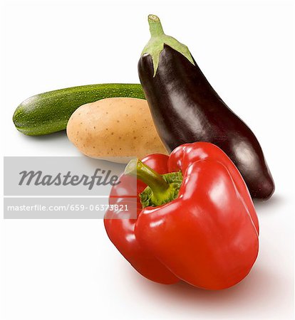 A pepper, an aubergine, a potato and an courgette