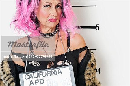 Portrait of senior punk woman making a face during mug shot