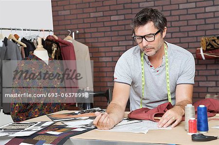 Mature male fashion designer working in design studio