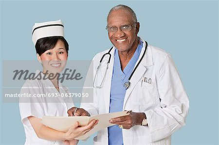 Portrait de professionnels de la santé heureux avec un rapport médical sur fond bleu clair