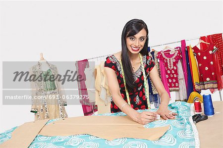 Portrait of beautiful Indian female fashion designer working