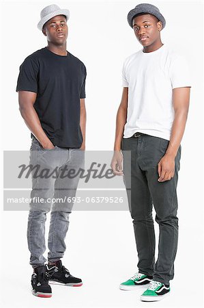 Portrait of two young African American men in casuals over gray background