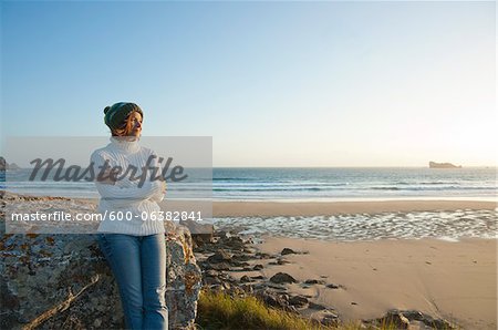 Woman Looking into the Distance at the Beach, Camaret-sur-Mer, Crozon Peninsula, Finistere, Brittany, France Woman Looking into the Distance at the Beach, Camaret-sur-Mer, Crozon Peninsula, Finistere, Brittany, France
