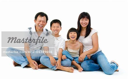 Fullbody happy Asian family sitting on white background