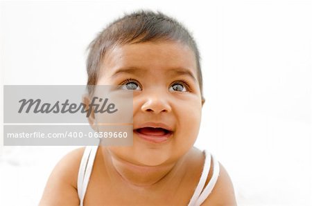 6 months old Indian baby girl having thought, looking up