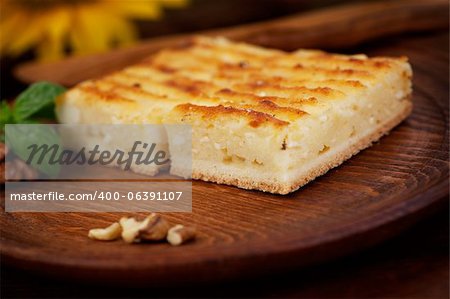 Cheese pie. Pastry cake with cheese on wooden background.