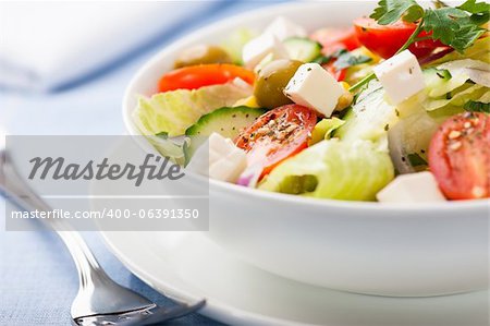close up of vegetable salad with feta cheese in a bowl