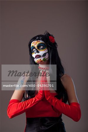 Praying Sugar skull girl in red evening dress and gloves