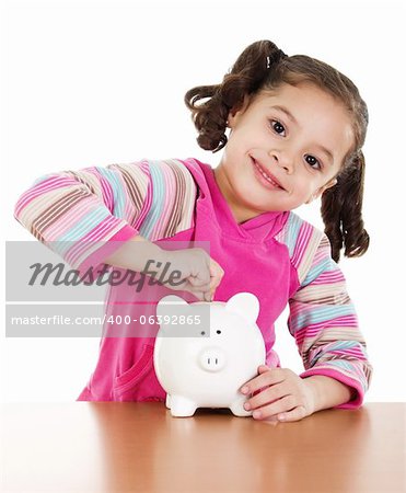 Stock image of little girl placing coin in piggy bank over white background